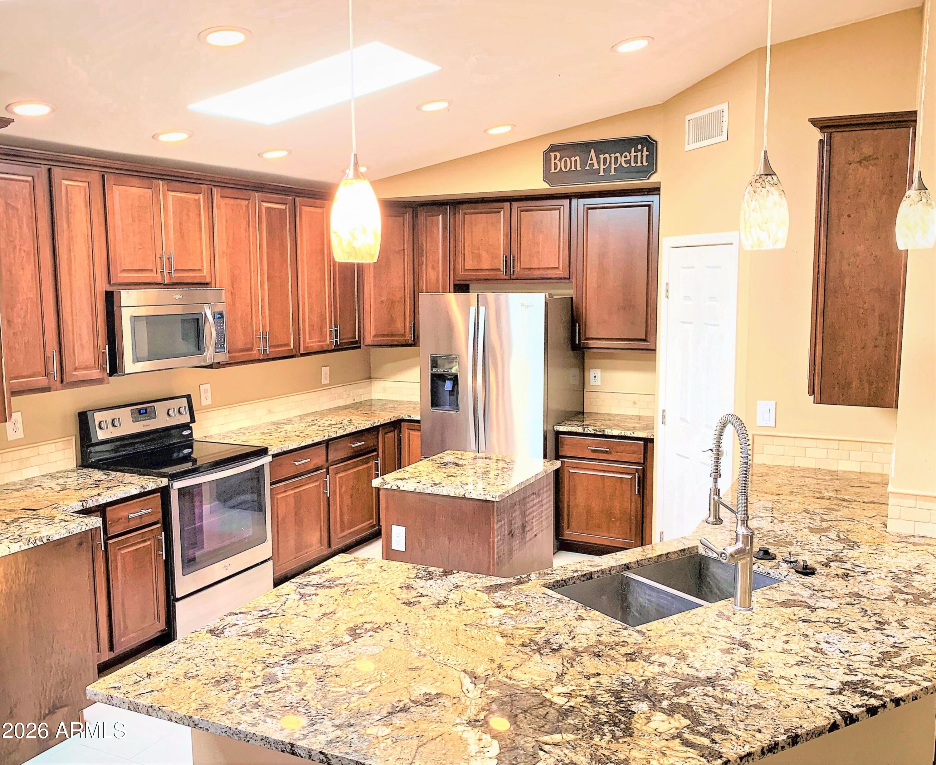 5916 East Spring Road Scottsdale, AZ 85254 - Photo 5 of 11 a kitchen with a refrigerator stove top oven and sink