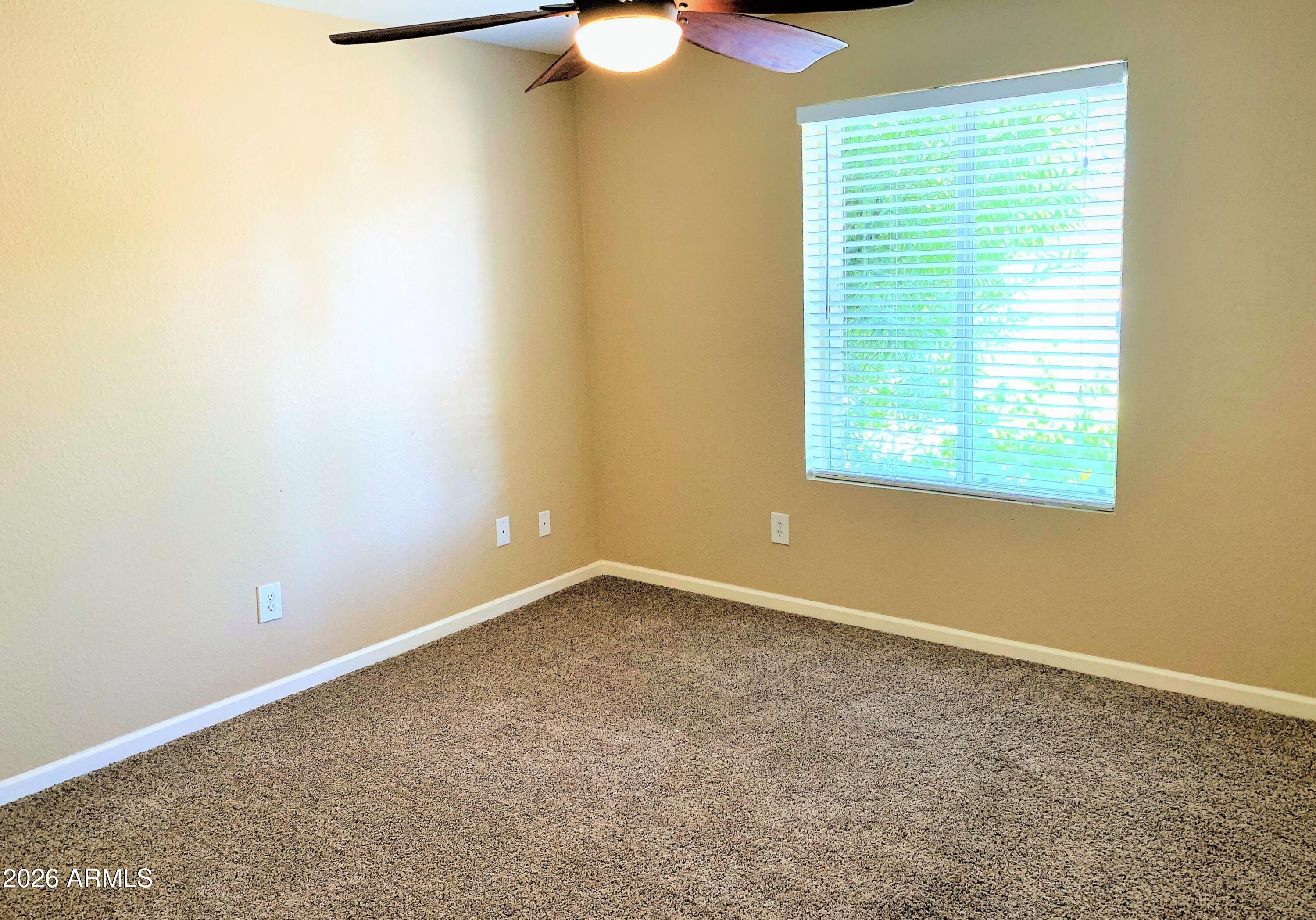 5916 East Spring Road Scottsdale, AZ 85254 - Photo 6 of 11 an empty room with a window and a chandelier fan