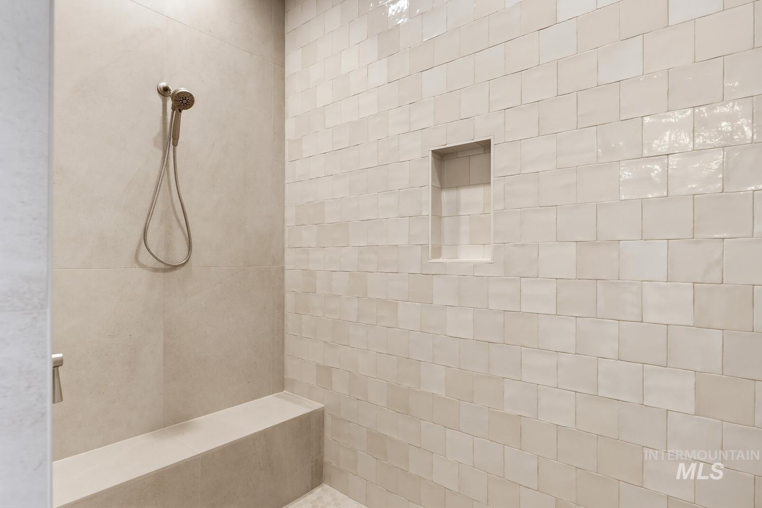 5054 Heritage Drive Marsing, ID 83639 - Photo 28 of 38 Shower enclosure featuring light-toned square wall tiles and a built-in shower niche