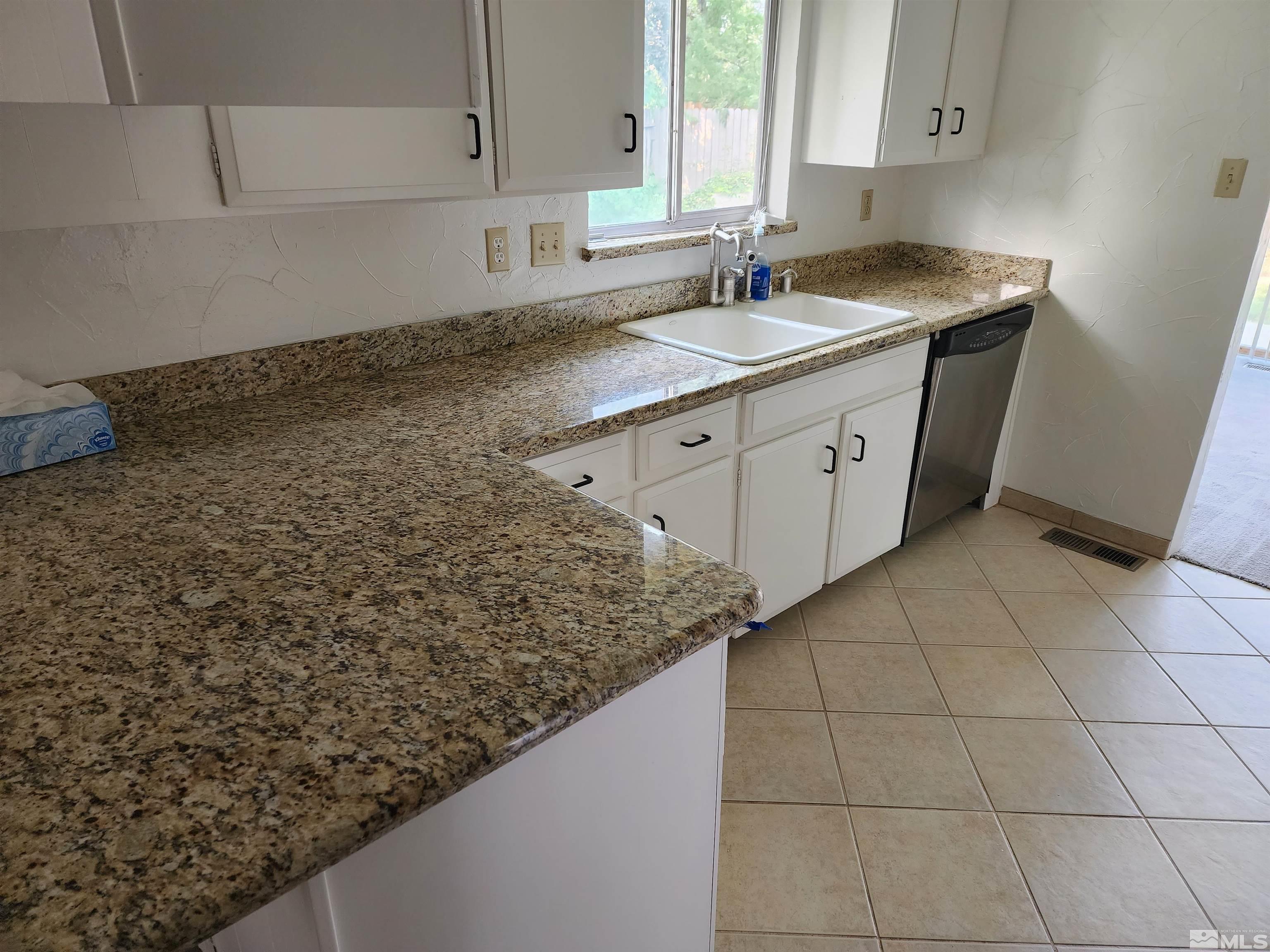 2945 Knight Road Reno, NV 89509 - Photo 3 of 11 a kitchen with a sink a stove and cabinets