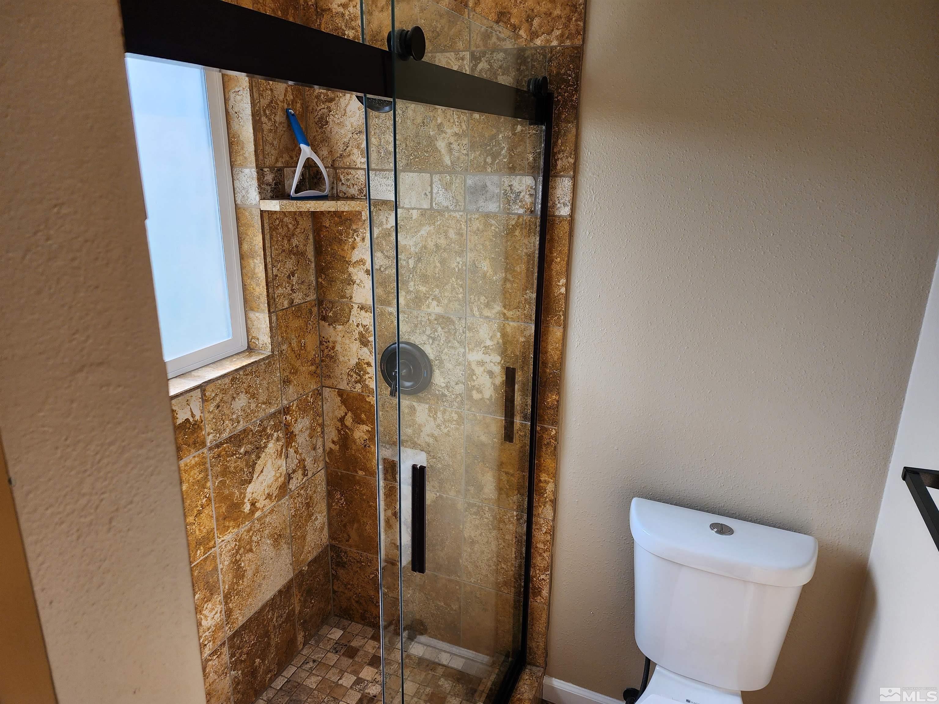 2945 Knight Road Reno, NV 89509 - Photo 6 of 11 a bathroom with a toilet and a shower