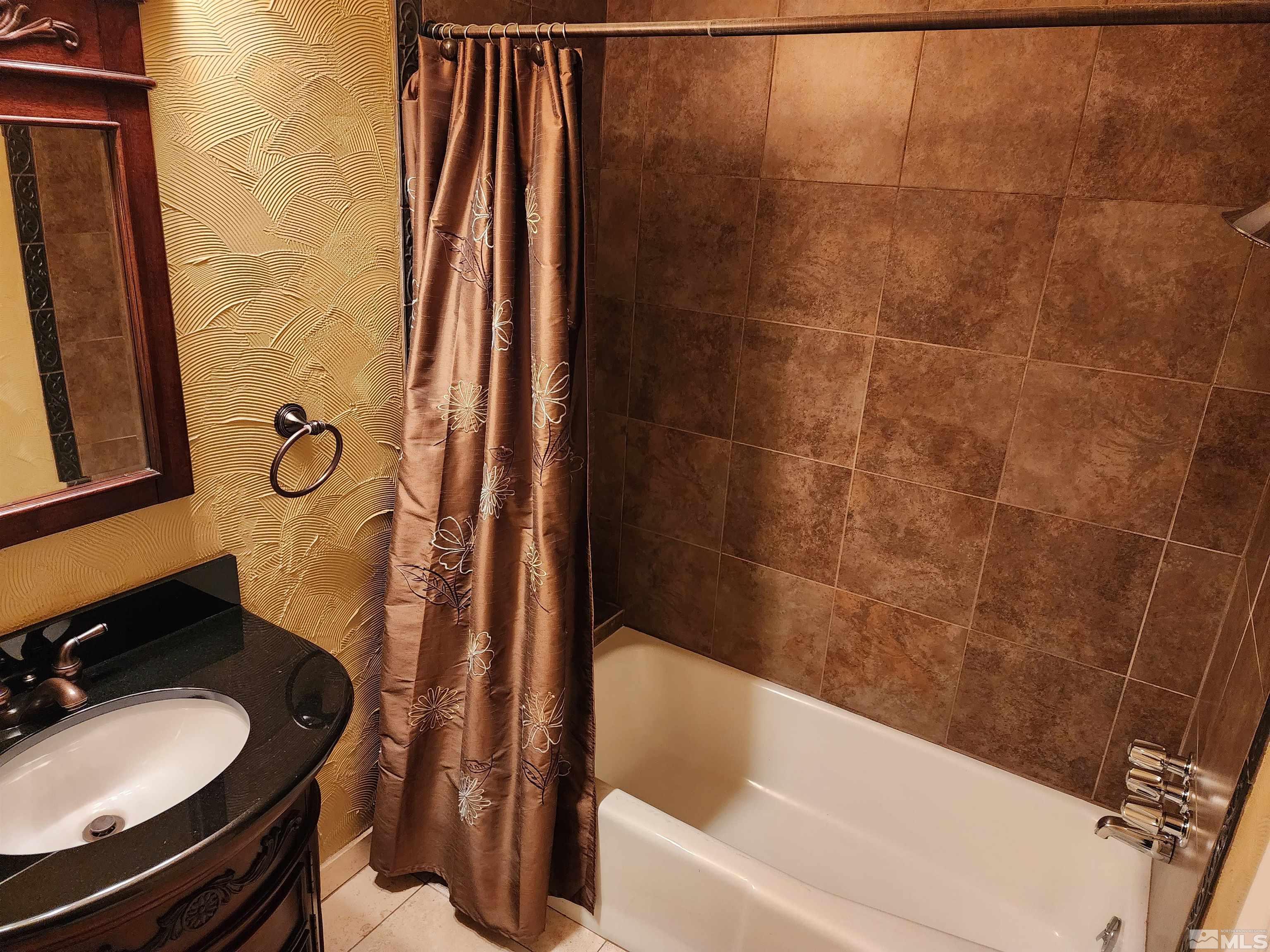 2945 Knight Road Reno, NV 89509 - Photo 7 of 11 a bathroom with a granite countertop sink toilet and shower