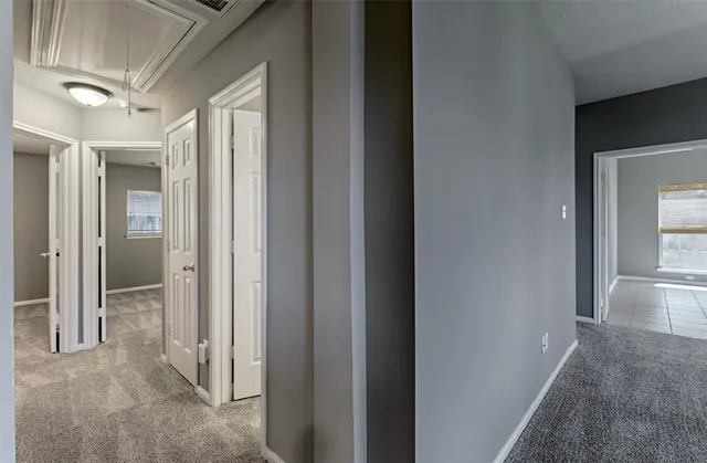a view of a hallway with wooden floor and entryway