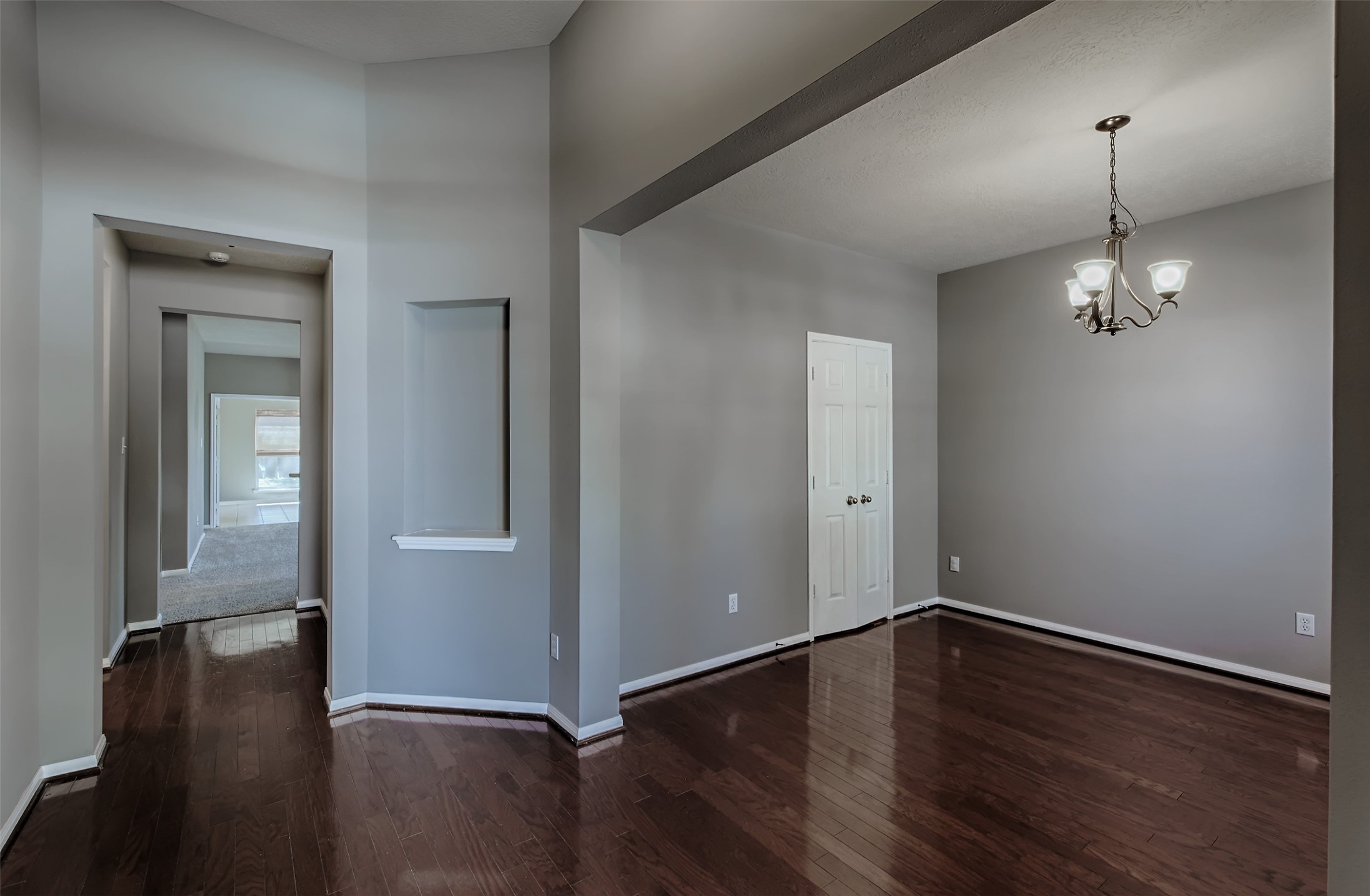 4018 Old Pine Grove Drive Humble, TX 77346 - Photo 2 of 26 an empty room with wooden floor mirror and windows