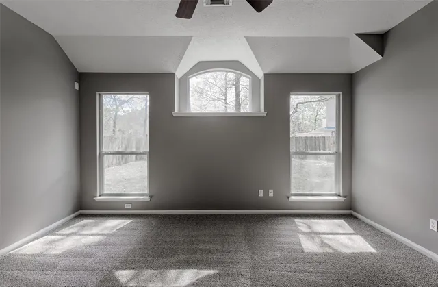 an empty room with windows and closet