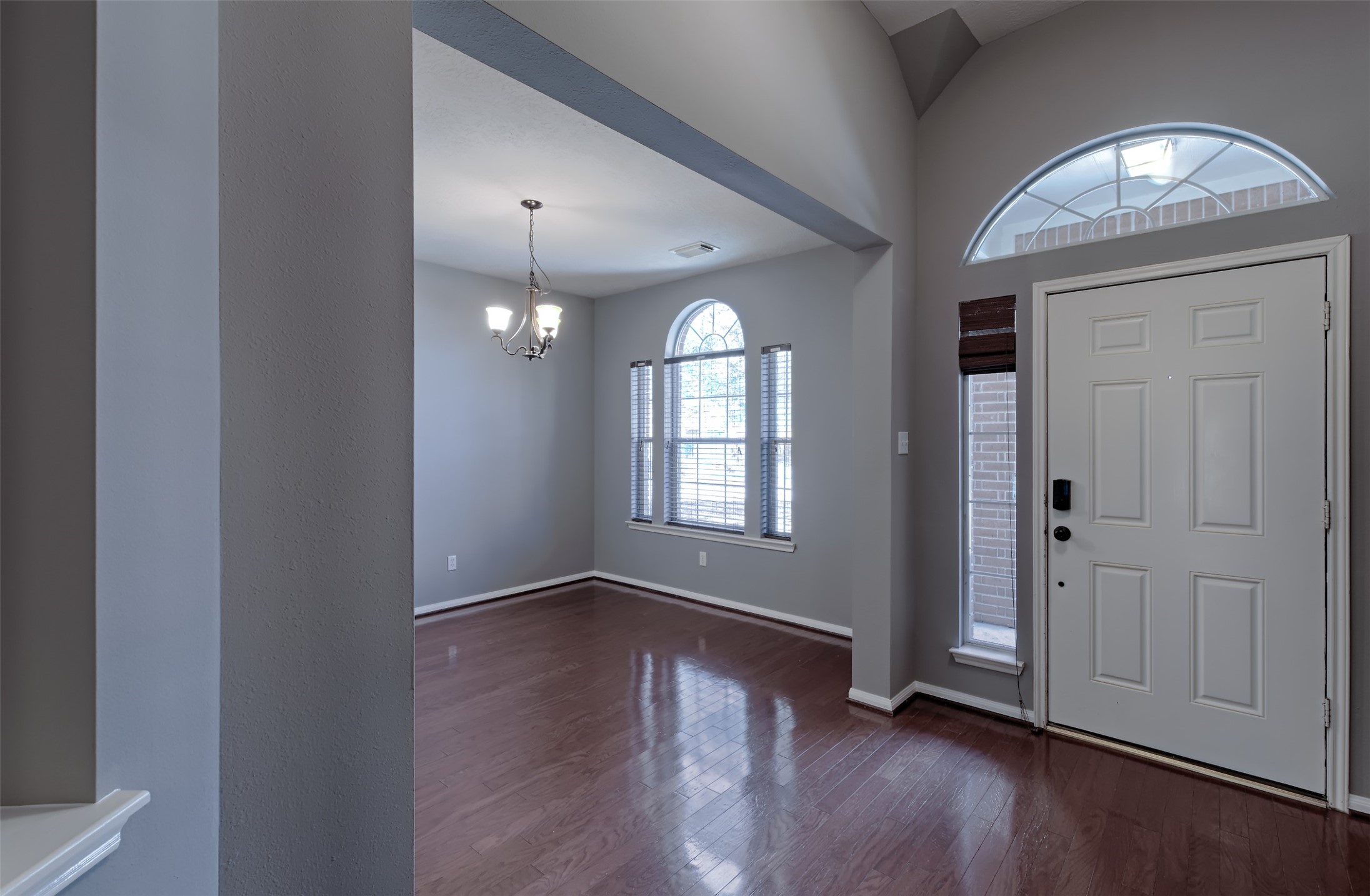4018 Old Pine Grove Drive Humble, TX 77346 - Photo 3 of 26 an empty room with wooden floor mirror and windows