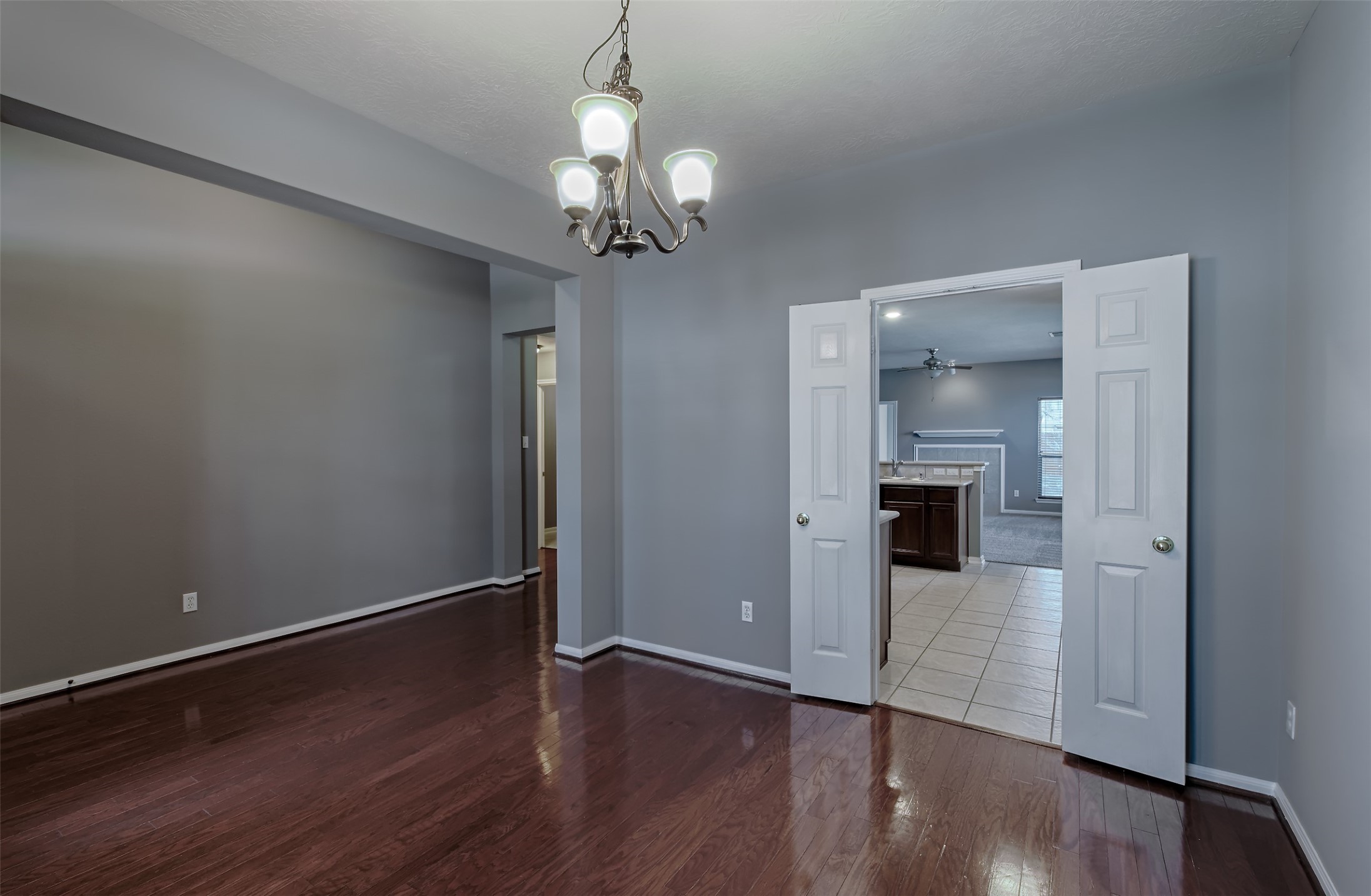 4018 Old Pine Grove Drive Humble, TX 77346 - Photo 4 of 26 a view of a hallway with wooden floor and a chandelier