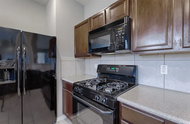a kitchen with a stove and a microwave