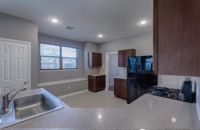 a kitchen with refrigerator and window