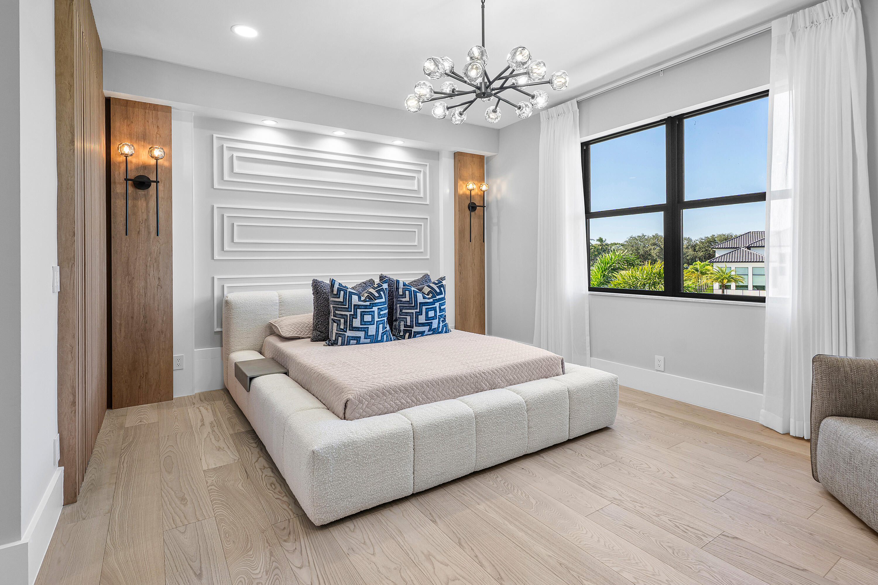 17709 Circle Pond Court Boca Raton, FL 33496 - Photo 27 of 50 a bedroom with a large bed and a chandelier