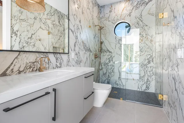 an aerial view of a house with a garden and lake view