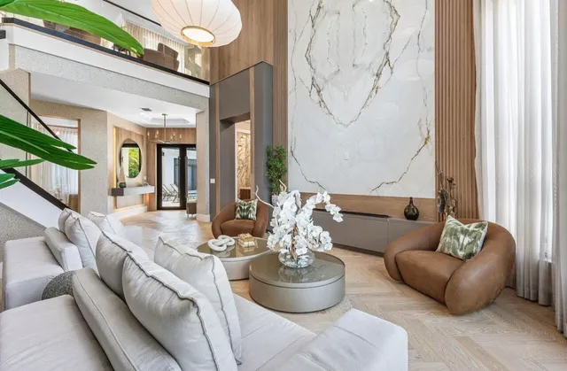 a living room with furniture and a chandelier