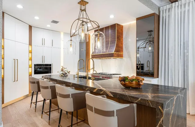 a kitchen with stainless steel appliances a sink a stove and a refrigerator