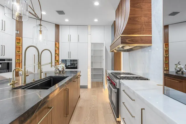 a kitchen with kitchen island stainless steel appliances a sink stove and refrigerator