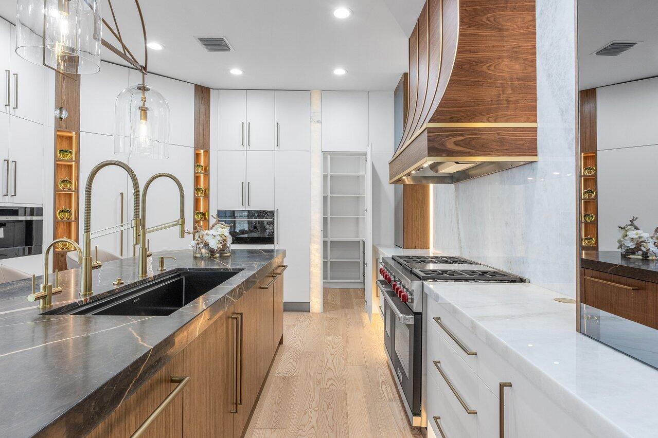 17709 Circle Pond Court Boca Raton, FL 33496 - Photo 9 of 50 a kitchen with kitchen island stainless steel appliances a sink stove and refrigerator
