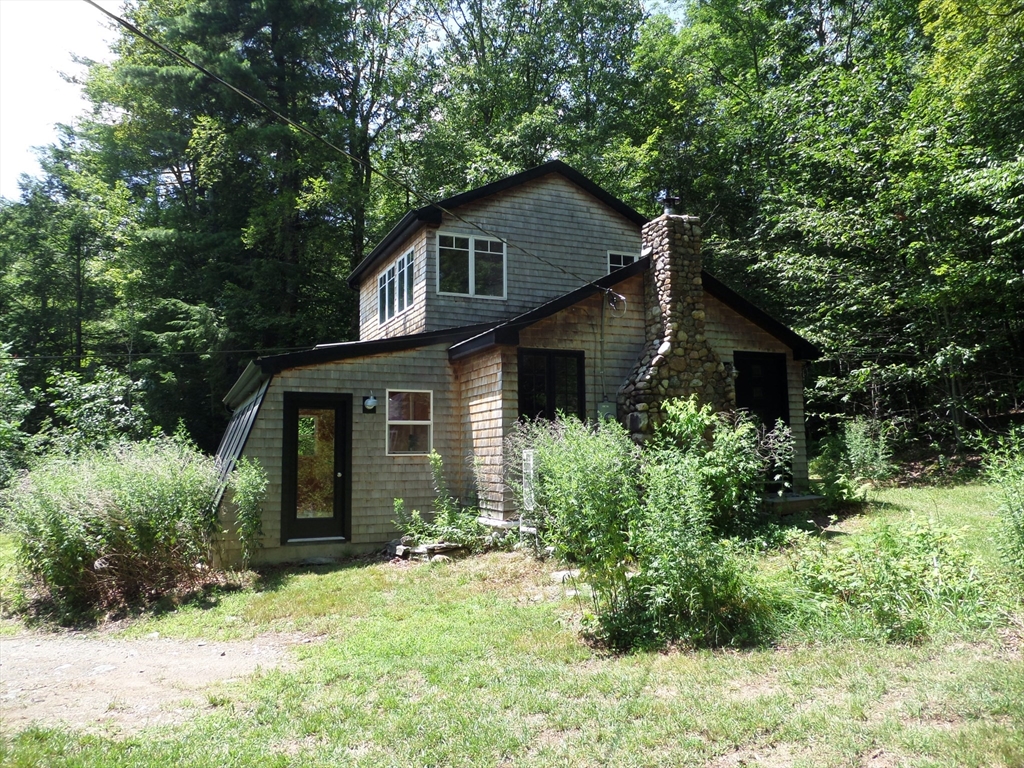 269 River Road Worthington, MA 01098 - Photo 3 of 32 a yellow house with trees in front of it