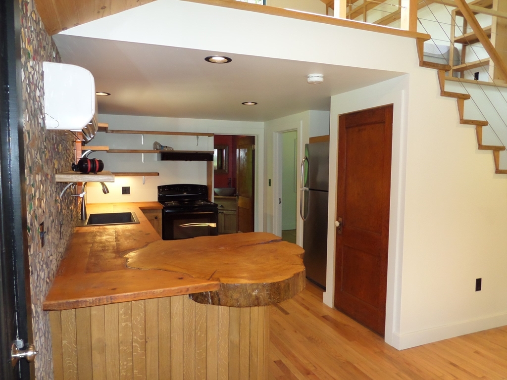 269 River Road Worthington, MA 01098 - Photo 8 of 32 a kitchen with stainless steel appliances a refrigerator and a stove top oven