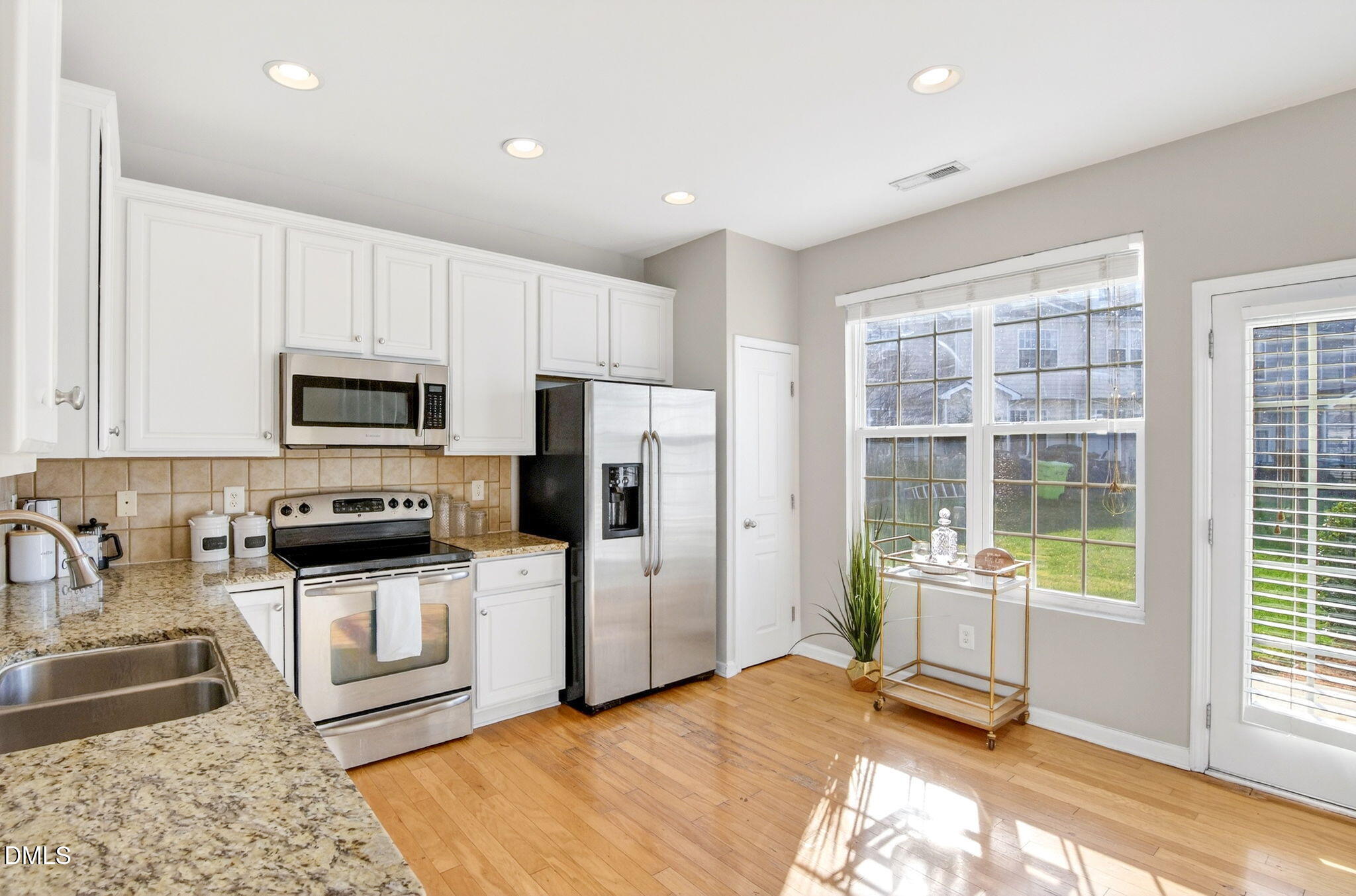 603 Cupola Drive Raleigh, NC 27603 - Photo 15 of 32 a kitchen with granite countertop a refrigerator and a stove top oven