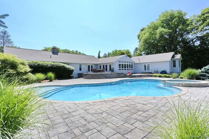 89 Spook Rock Road Suffern, NY 10901 - Photo 39 of 44 a view of a house with swimming pool and sitting area