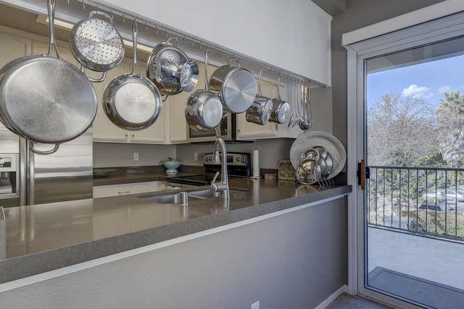 108 Arbor Way Milpitas, CA 95035 - Photo 13 of 26 a kitchen with a wooden floor and a clock on wall