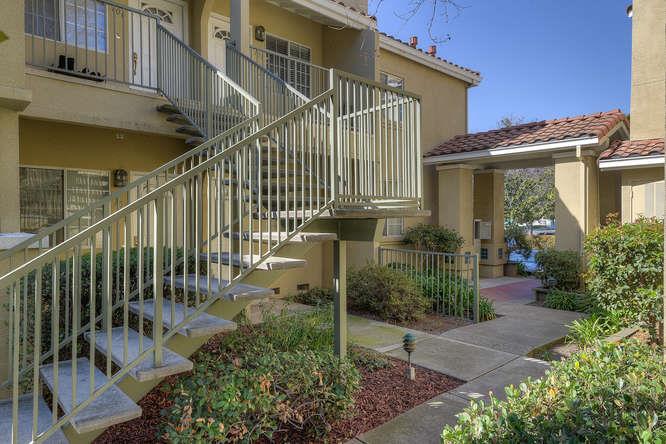 108 Arbor Way Milpitas, CA 95035 - Photo 3 of 26 a view of a house with brick walls and flower plants in front of main door