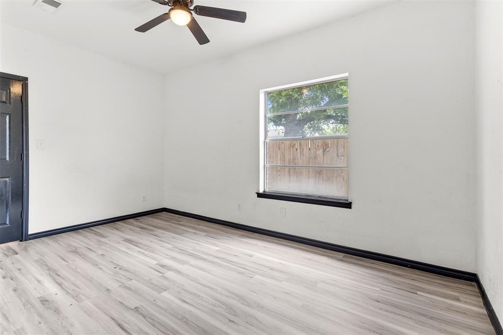 2802 Spring Valley Drive Bedford, TX 76021 - Photo 8 of 24 an empty room with wooden floor and windows