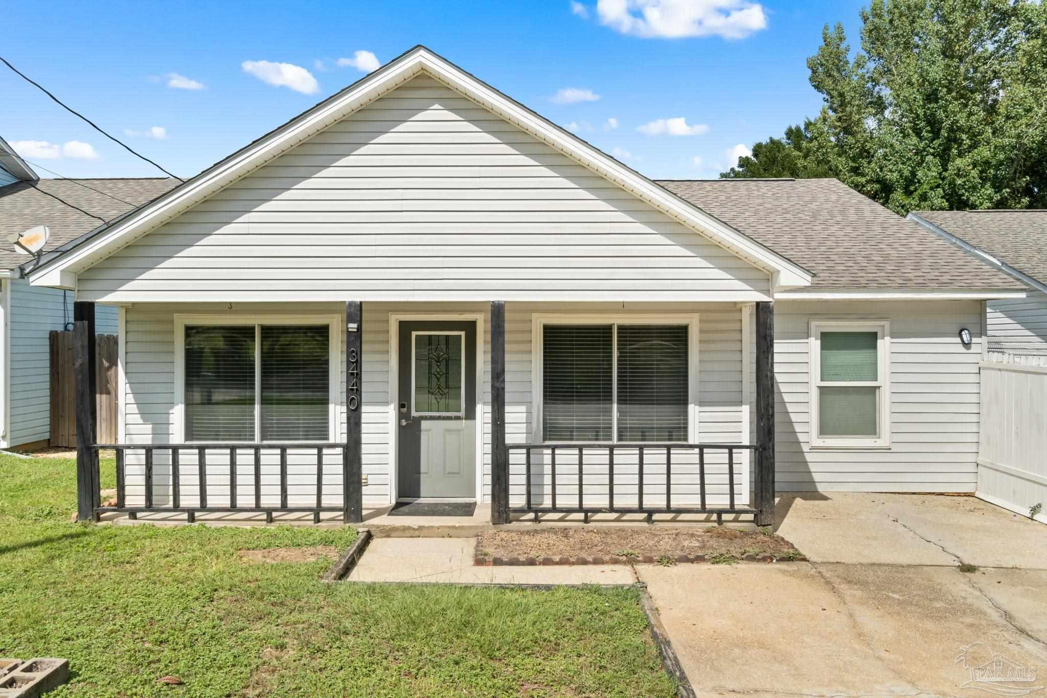 3440 Riverside Drive Pensacola, FL 32514 - Photo 1 of 26 a front view of a house with a yard and porch