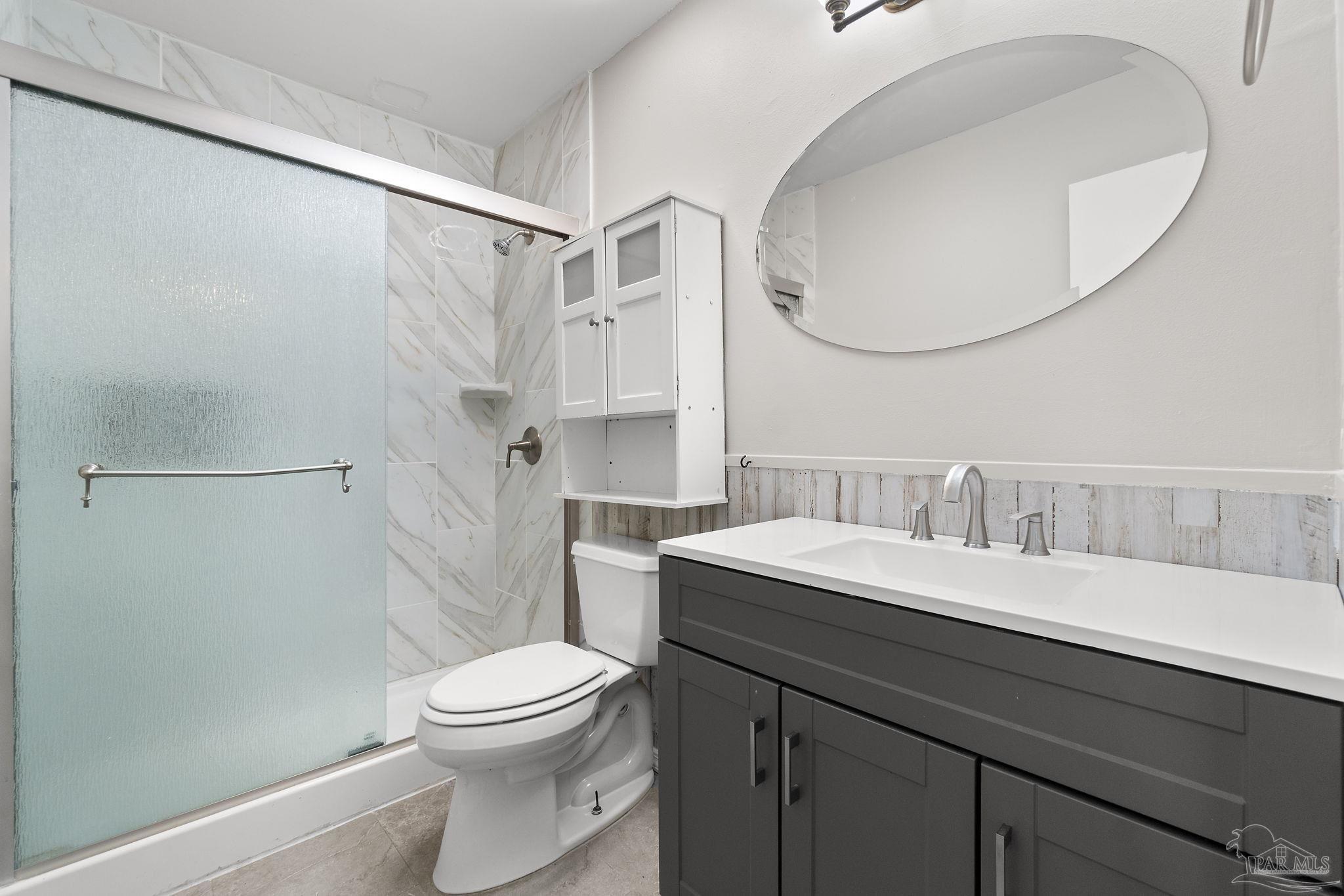 3440 Riverside Drive Pensacola, FL 32514 - Photo 14 of 26 a bathroom with a sink a toilet and a mirror