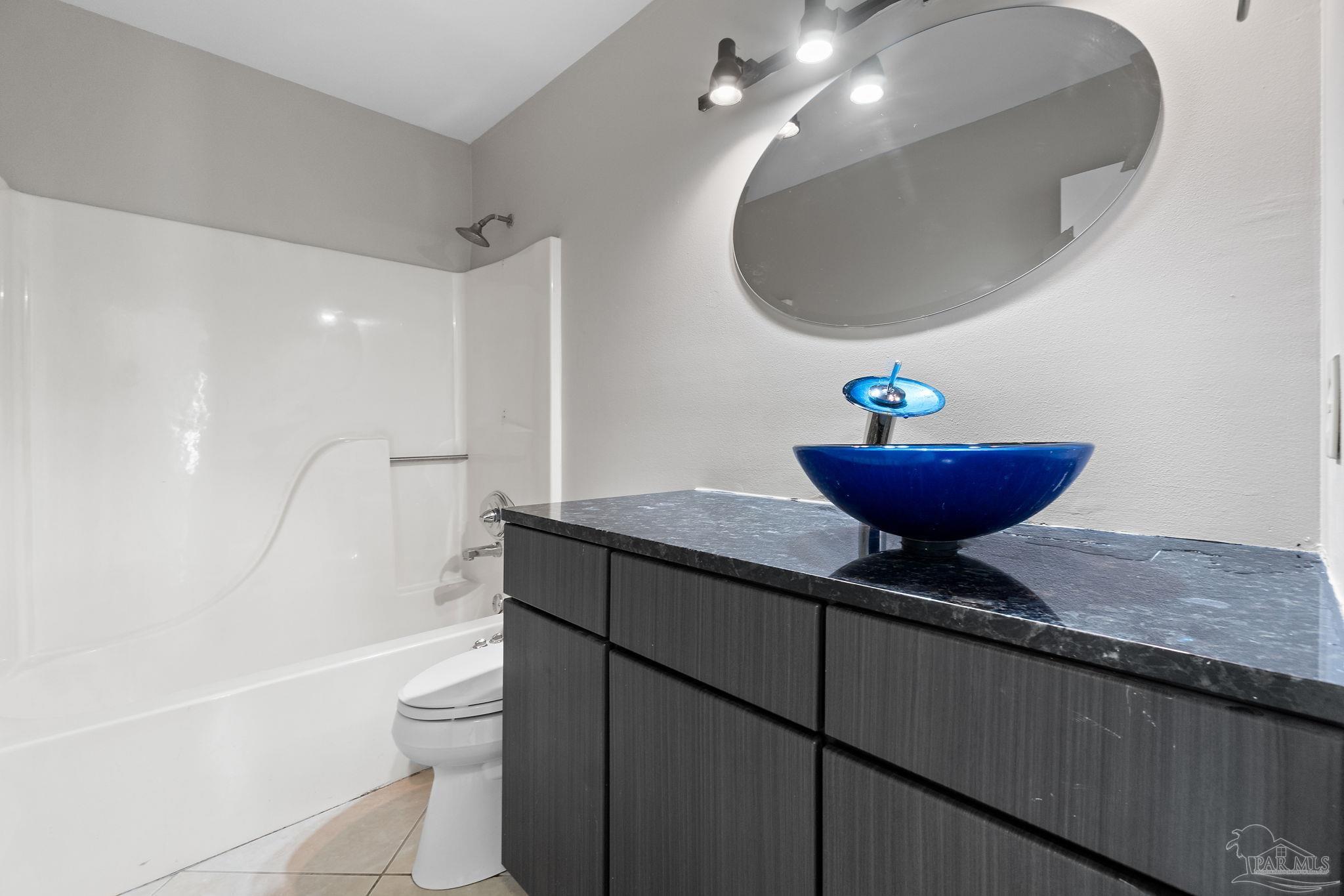 3440 Riverside Drive Pensacola, FL 32514 - Photo 18 of 26 a bathroom with a granite countertop sink toilet and a mirror