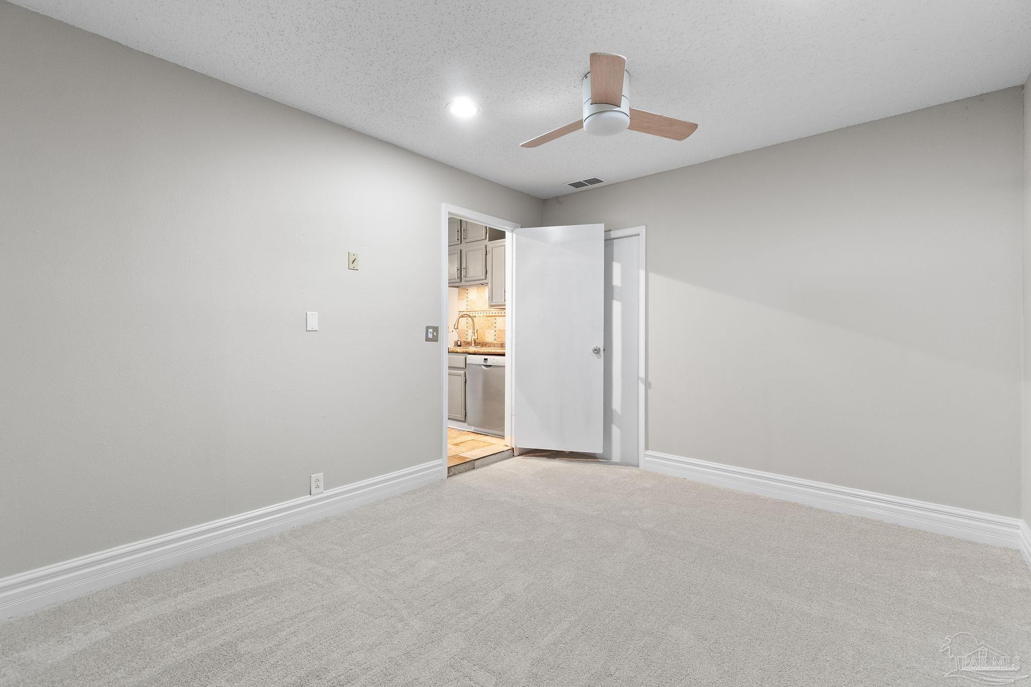 3440 Riverside Drive Pensacola, FL 32514 - Photo 21 of 26 an empty room with a empty space and a ceiling fan