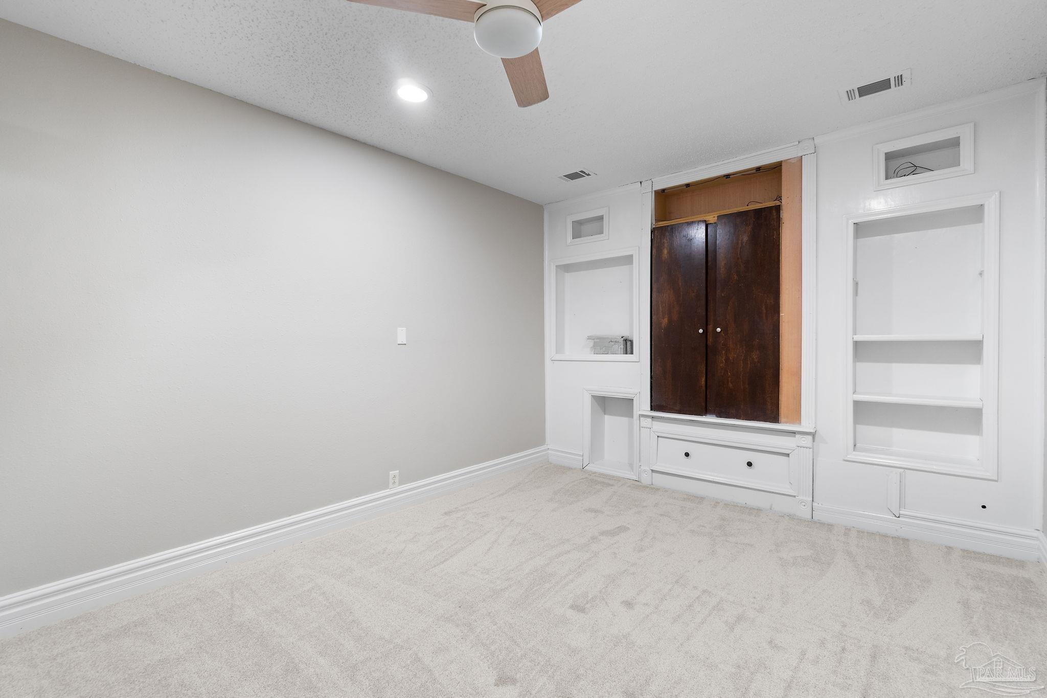 3440 Riverside Drive Pensacola, FL 32514 - Photo 22 of 26 an empty room with cabinet and mirrors