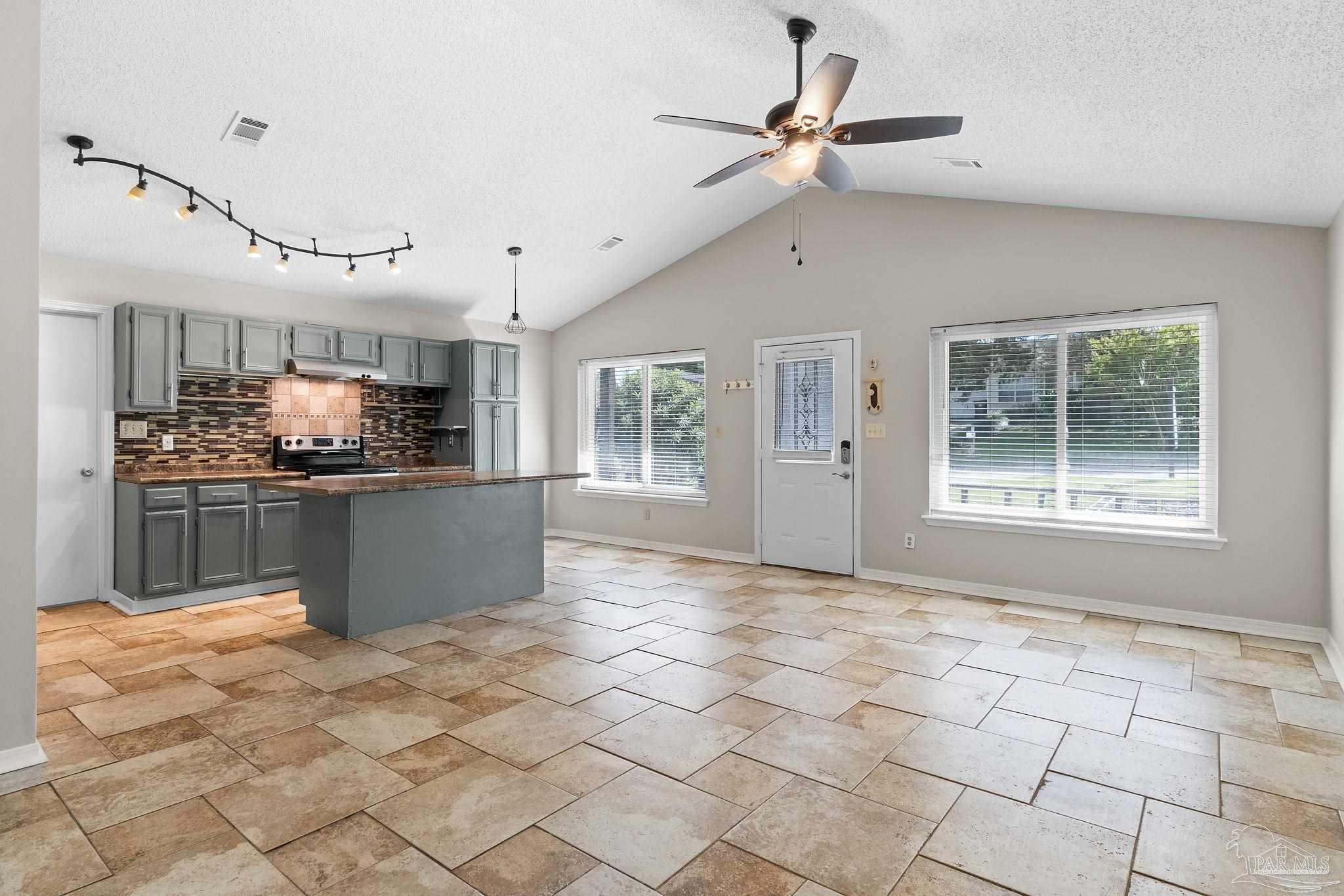 3440 Riverside Drive Pensacola, FL 32514 - Photo 5 of 26 a kitchen with stainless steel appliances kitchen island granite countertop a stove cabinets and a sink