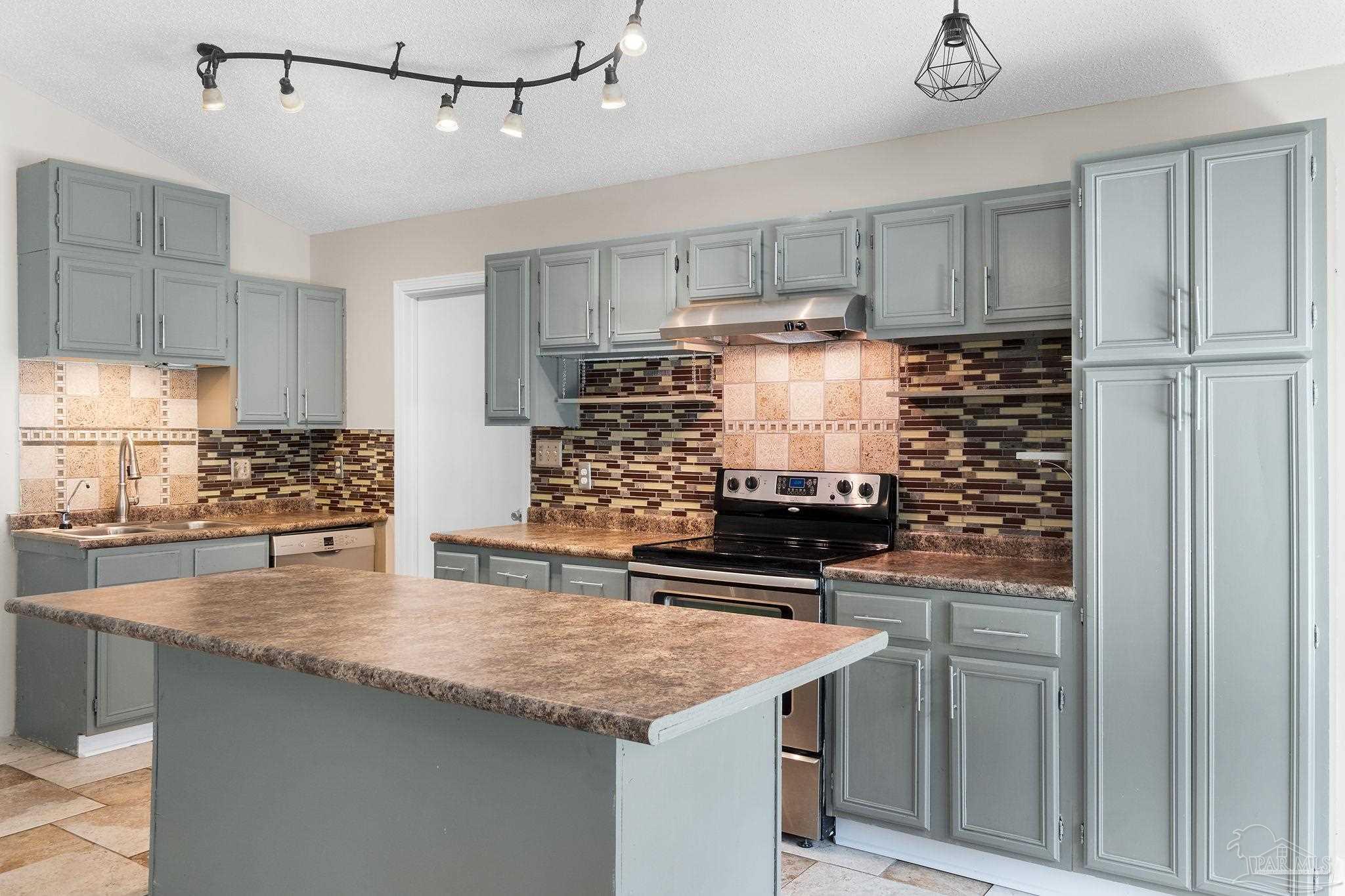 3440 Riverside Drive Pensacola, FL 32514 - Photo 7 of 26 a kitchen with stainless steel appliances granite countertop a sink stove and refrigerator