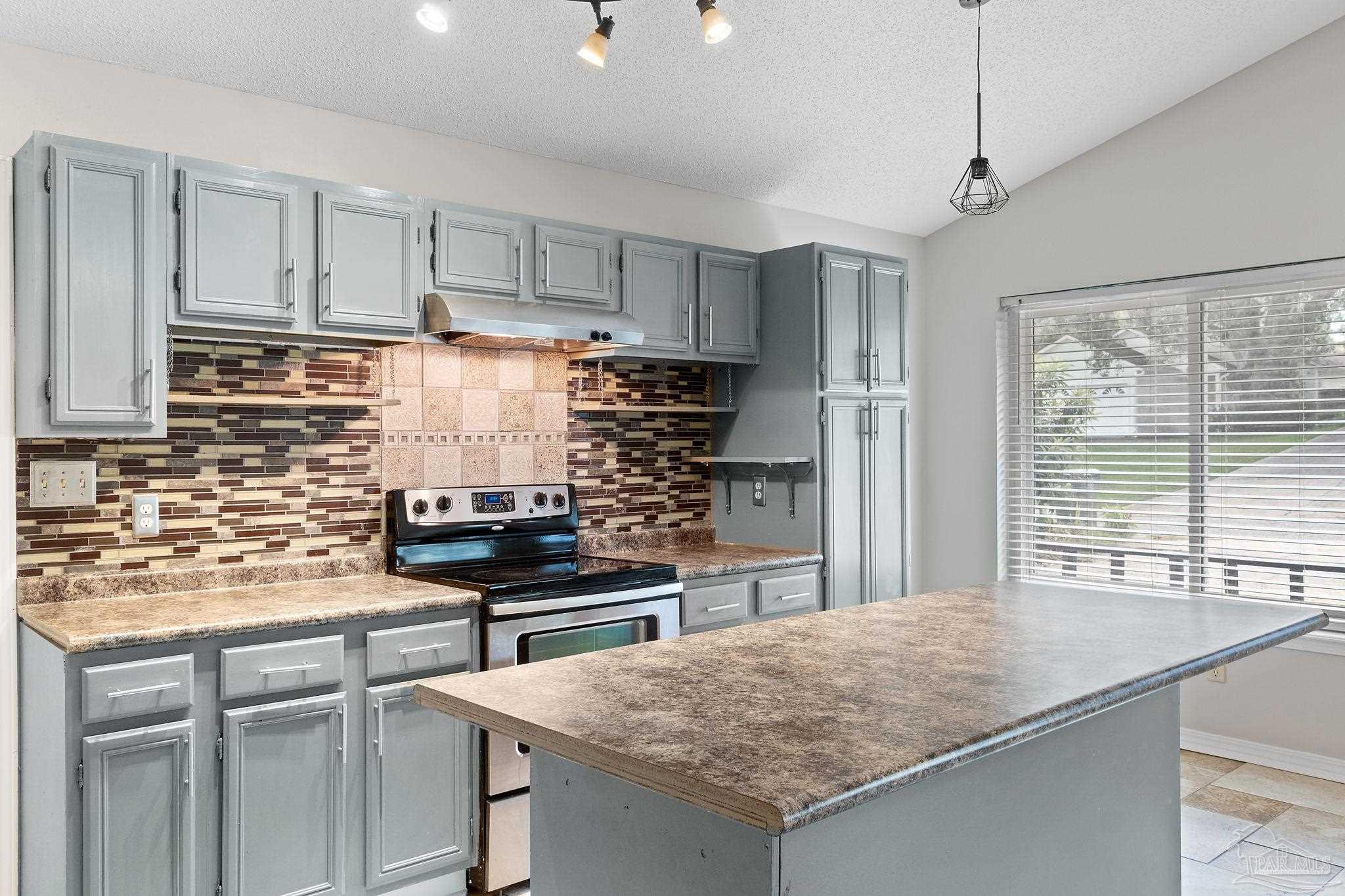 3440 Riverside Drive Pensacola, FL 32514 - Photo 8 of 26 a kitchen with stainless steel appliances granite countertop a sink stove and refrigerator