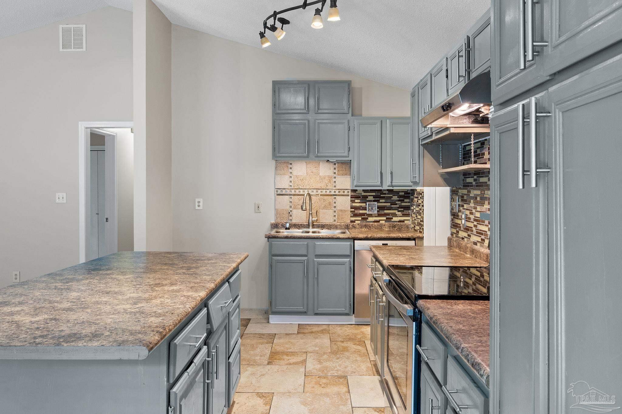 3440 Riverside Drive Pensacola, FL 32514 - Photo 9 of 26 a kitchen with granite countertop stainless steel appliances and wooden cabinets