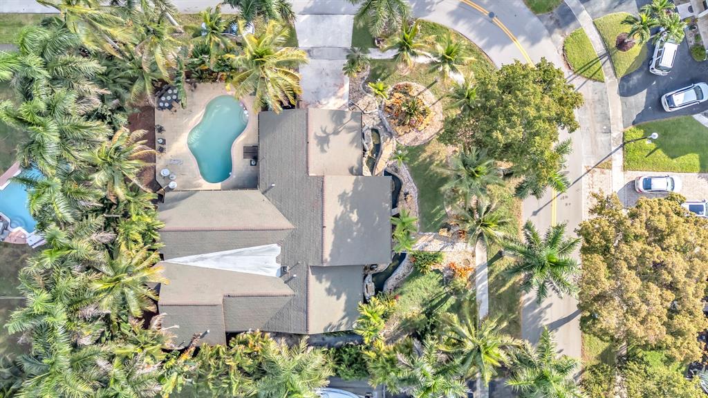 an aerial view of a house with a yard and garden