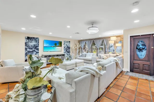 a living room with fireplace furniture and a flat screen tv