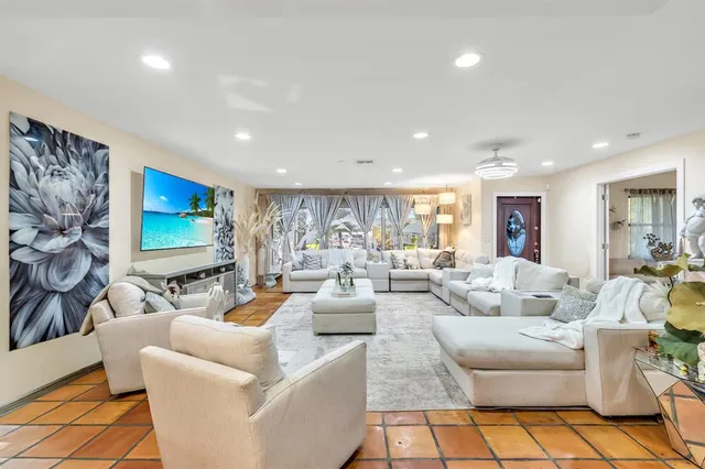 a living room with fireplace furniture and a flat screen tv