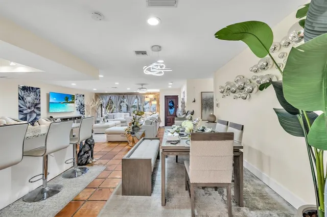 a living room with furniture potted plant and a chandelier