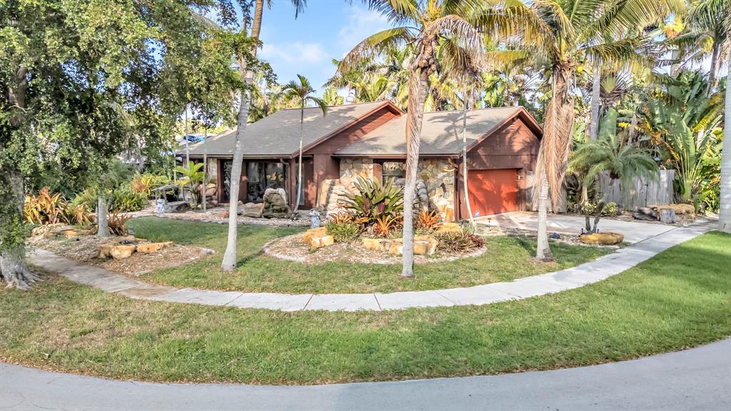 980 Southwest 70th Avenue Plantation, FL 33317 - Photo 2 of 42 front view of a house with a yard