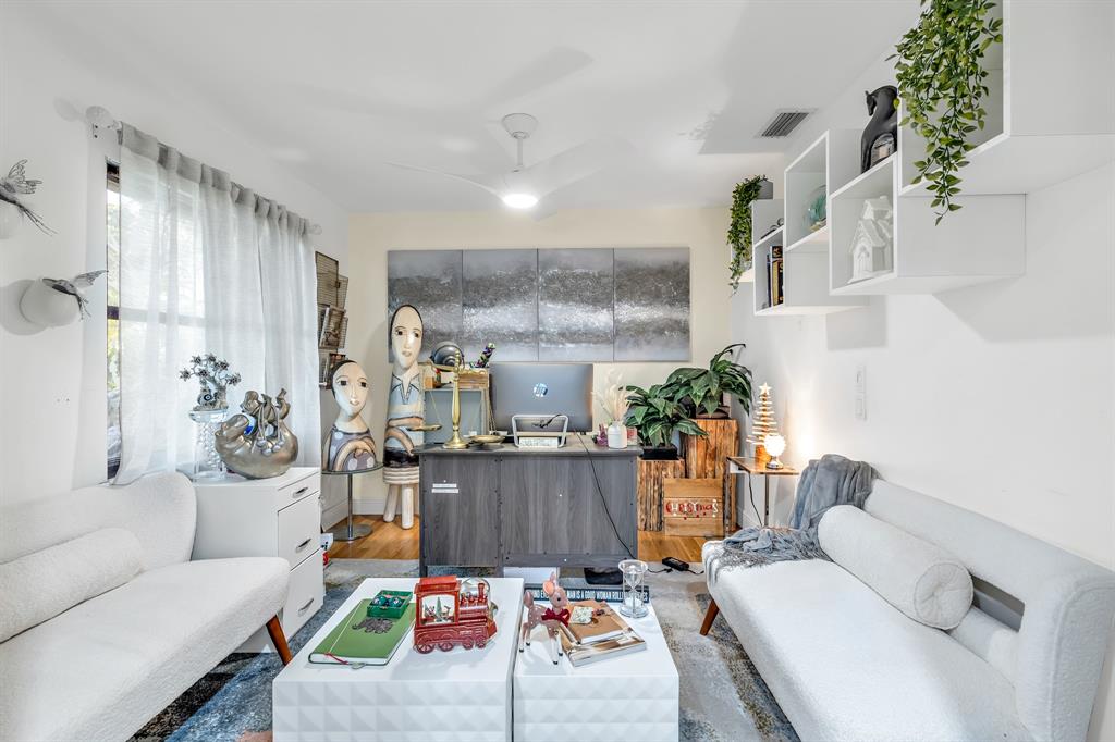 980 Southwest 70th Avenue Plantation, FL 33317 - Photo 23 of 42 a living room with furniture and a chandelier
