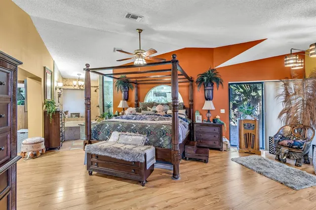 a bedroom with furniture and a chandelier
