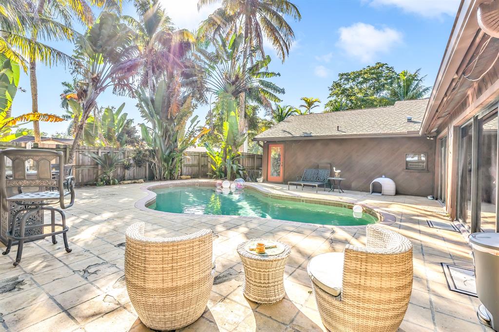 980 Southwest 70th Avenue Plantation, FL 33317 - Photo 41 of 42 a view of a patio with table and chairs potted plants with sky view