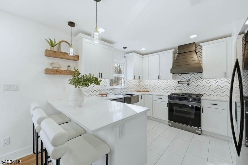 962 Brown Road Bridgewater, NJ 08807 - Photo 12 of 46 a kitchen with stainless steel appliances kitchen island granite countertop a sink and white cabinets
