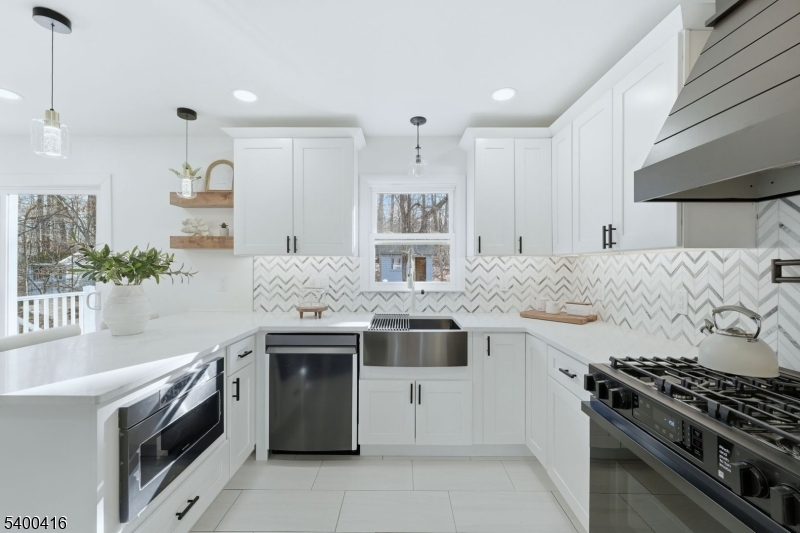 962 Brown Road Bridgewater, NJ 08807 - Photo 13 of 46 a kitchen with stainless steel appliances granite countertop a stove and a sink