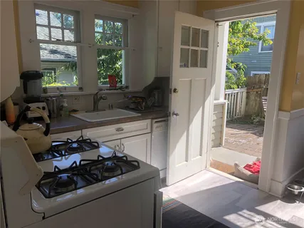 a kitchen that has a sink and a stove