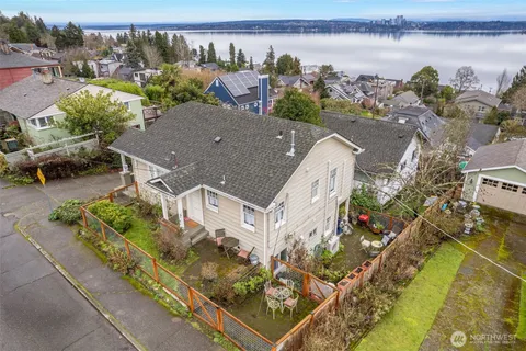 an aerial view of a house with a garden and lake view