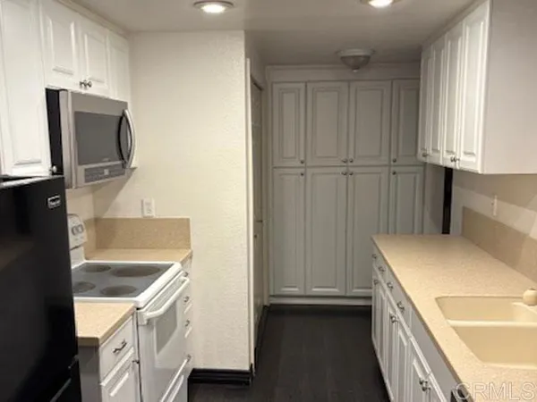 a kitchen with a sink and a refrigerator