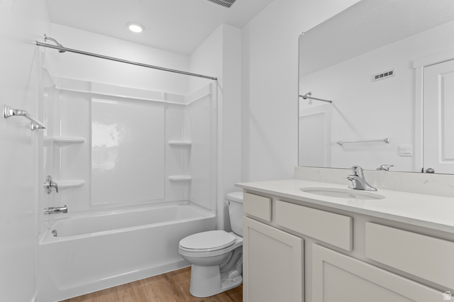 1851 East Corriente Drive, Unit 1166 Salem, UT 84653 - Photo 12 of 16 Full bath with vanity, light wood-style flooring, and washtub / shower combination