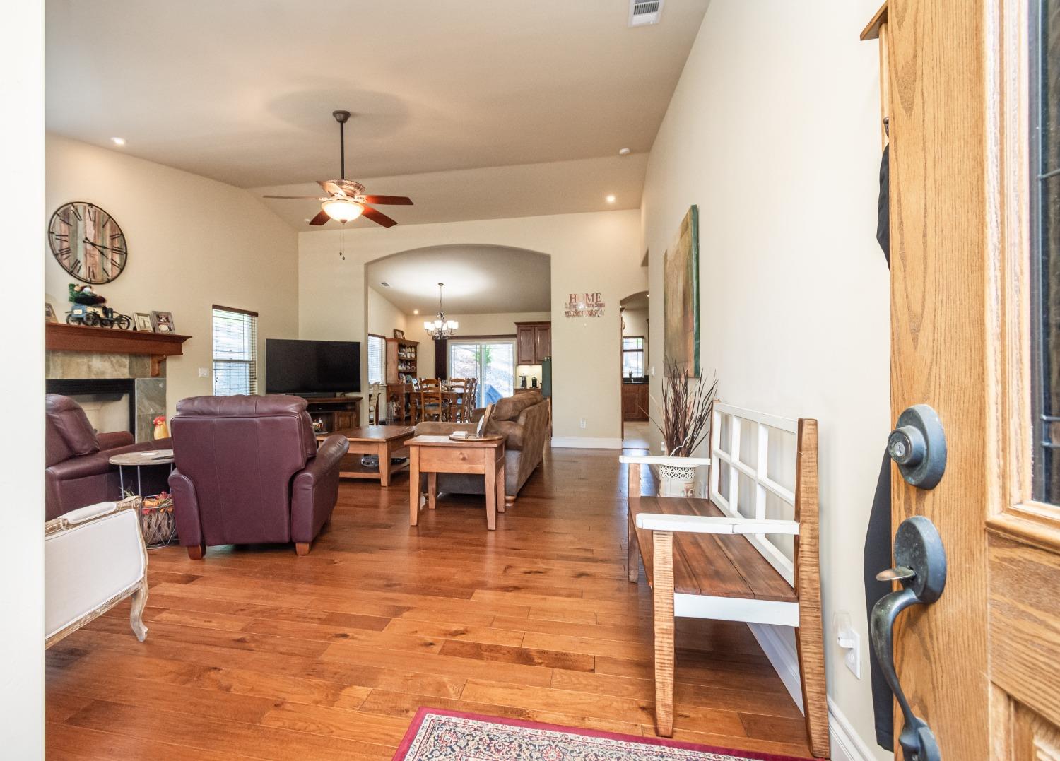 6570 Mosquito Road Placerville, CA 95667 - Photo 14 of 56 a view of a dining room with furniture a chandelier and wooden floor